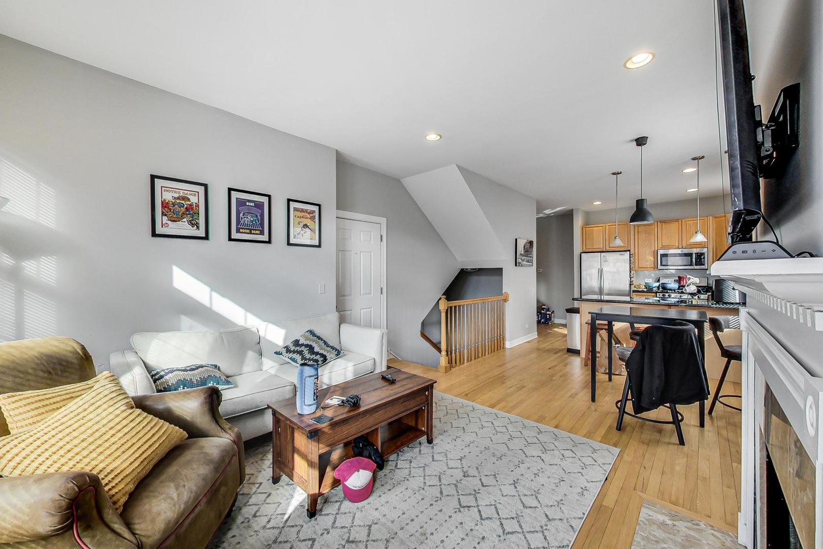 1330 West Fletcher Street, Unit 1 Chicago, IL 60657 - Photo 9 of 42 a living room with furniture a rug and kitchen view