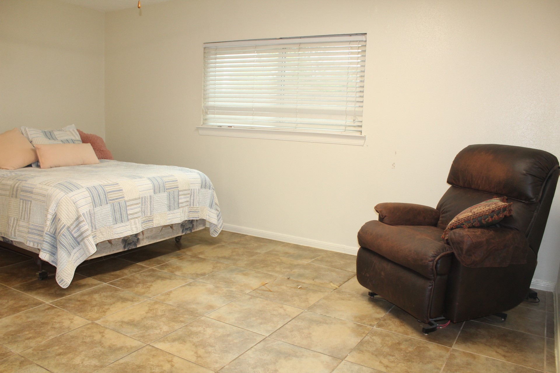 11303 Windmark Drive Houston, TX 77099 - Photo 24 of 29 a bed sitting in a bedroom next to a window