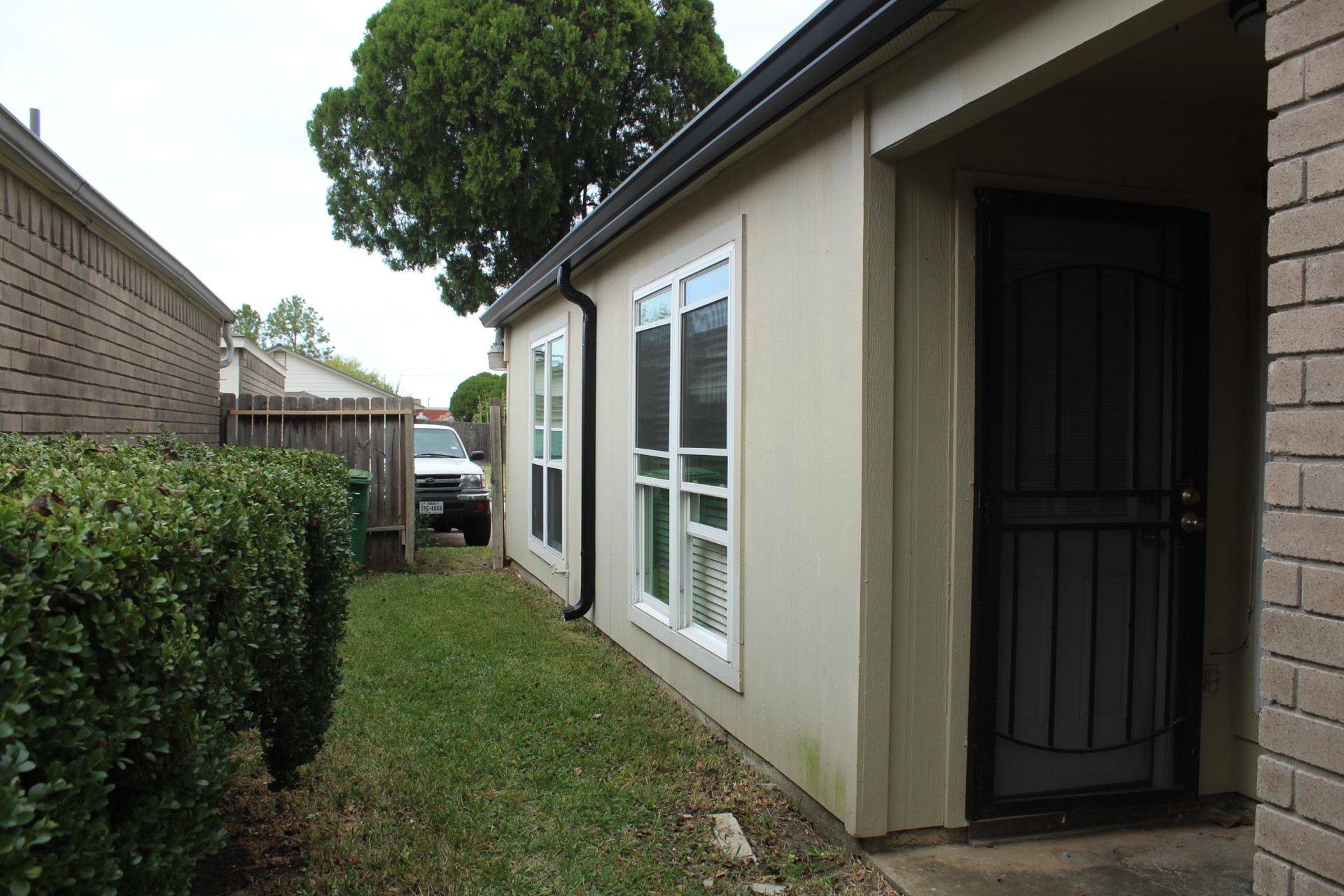 11303 Windmark Drive Houston, TX 77099 - Photo 5 of 29 a view of backyard with potted plants and floor to ceiling window