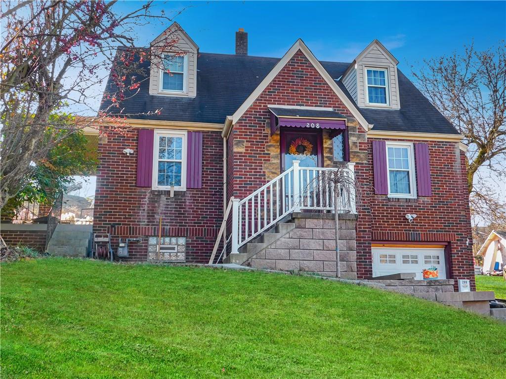 208 Springfield Avenue Washington, PA 15301 - Photo 2 of 19 a front view of a house with a yard and green space