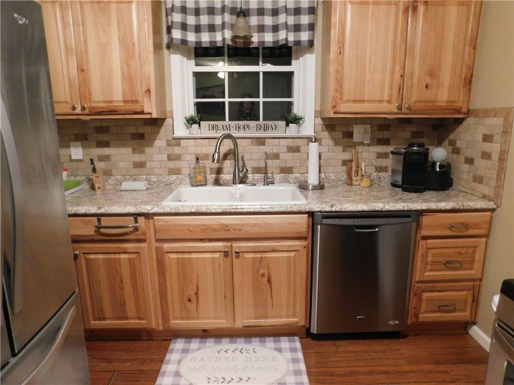 208 Springfield Avenue Washington, PA 15301 - Photo 4 of 19 a kitchen with stainless steel appliances granite countertop a sink stove and cabinets
