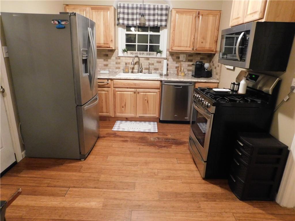 208 Springfield Avenue Washington, PA 15301 - Photo 5 of 19 a kitchen with stainless steel appliances granite countertop a refrigerator stove and sink