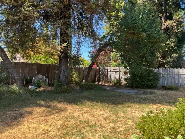a backyard of a house with table and chairs