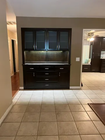 a kitchen with a refrigerator and cabinets
