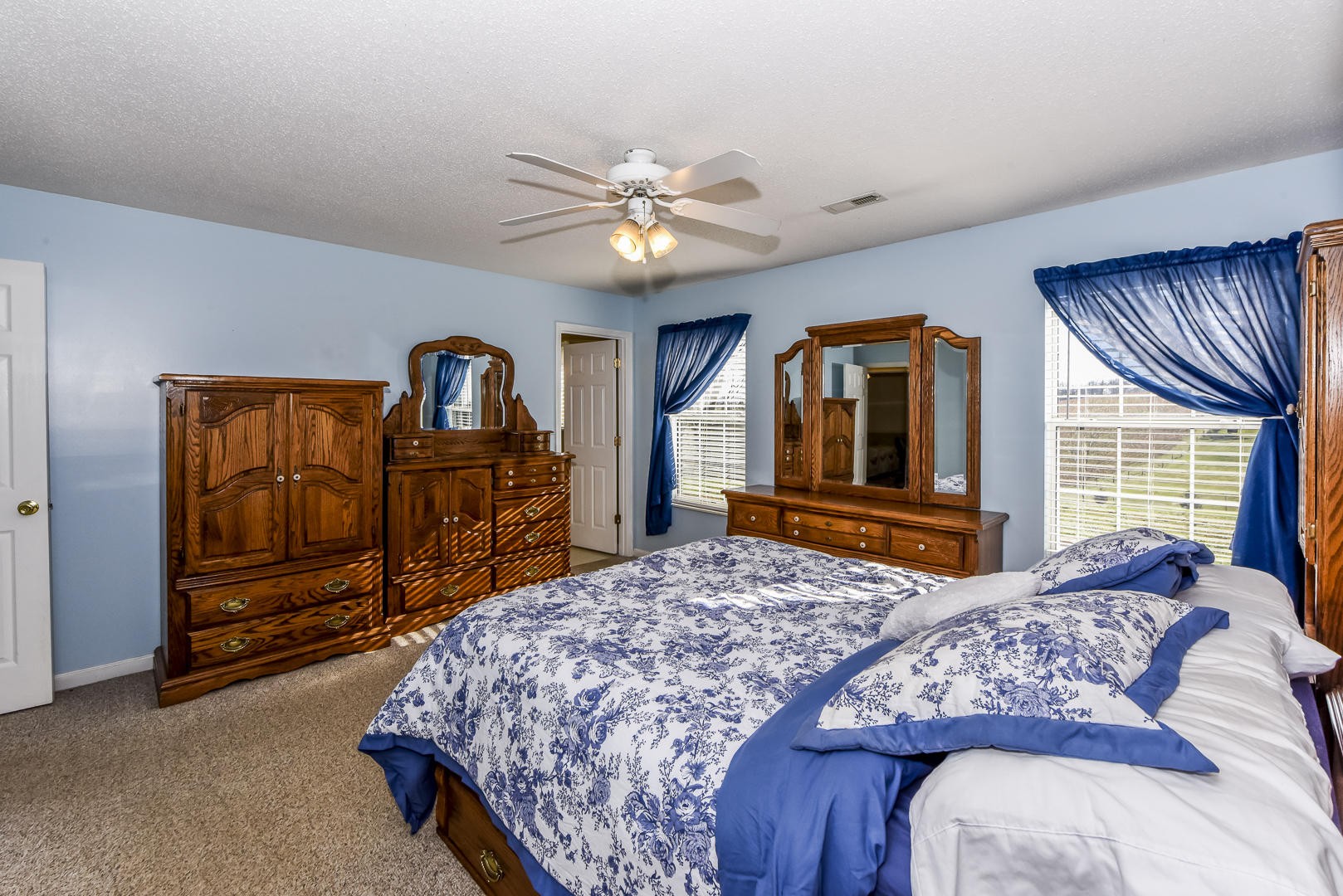 1409 Lambert Road Greenback, TN 37742 - Photo 15 of 28 a bedroom with a large bed and two windows