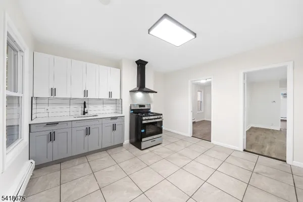 a kitchen with stainless steel appliances granite countertop a sink and cabinets
