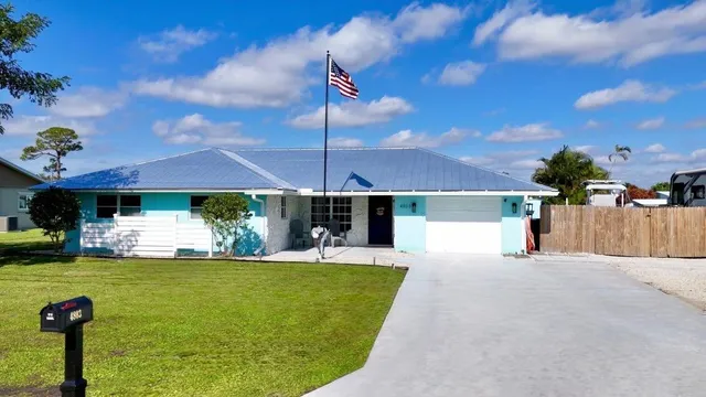 a view of a patio with table and chairs a barbeque