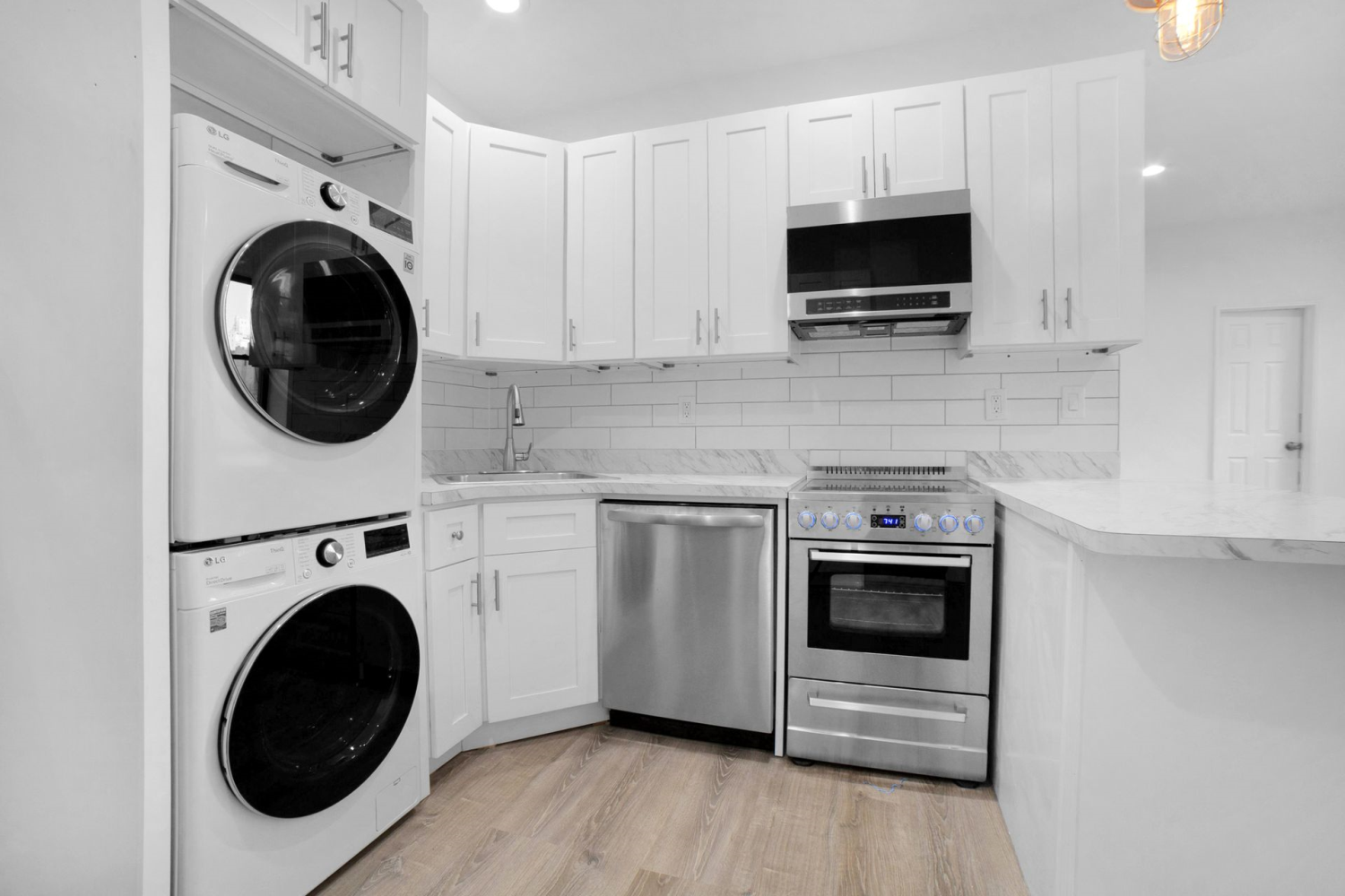 a kitchen with sink a washer and dryer