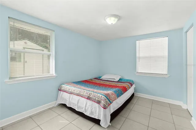 a bed sitting in a bedroom next to a window