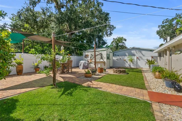 a view of a patio with table and chairs potted plants