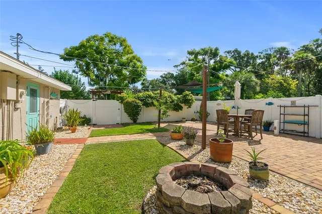 a view of a backyard with plants and a patio