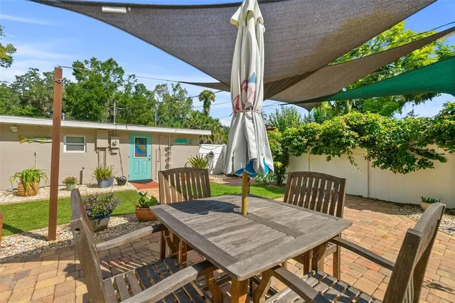 a view of backyard with a tree