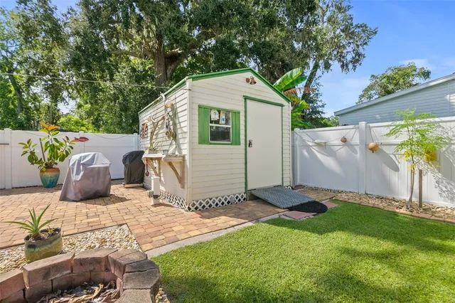 a backyard of a house with table and chairs