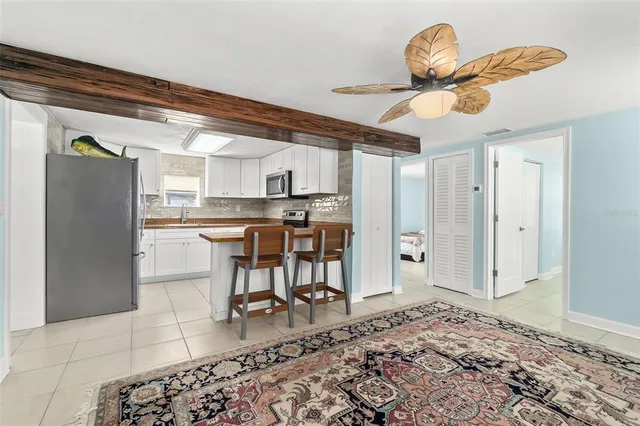 a kitchen with stainless steel appliances kitchen island granite countertop a refrigerator and a stove top oven