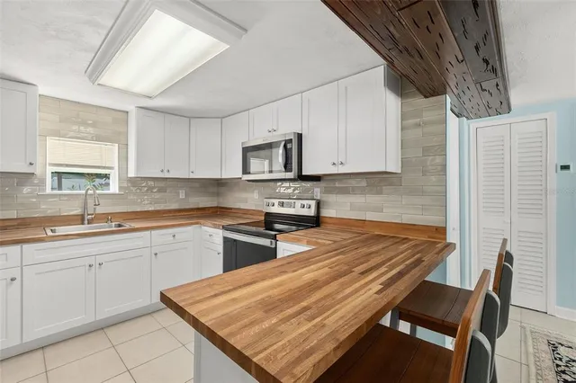 a kitchen with wooden cabinets and a stove top oven