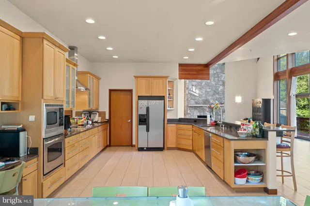a kitchen with stainless steel appliances granite countertop a refrigerator and a sink