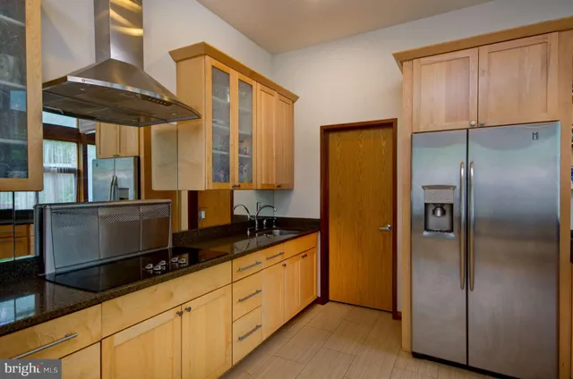 a large white kitchen with lots of counter furniture and a sink
