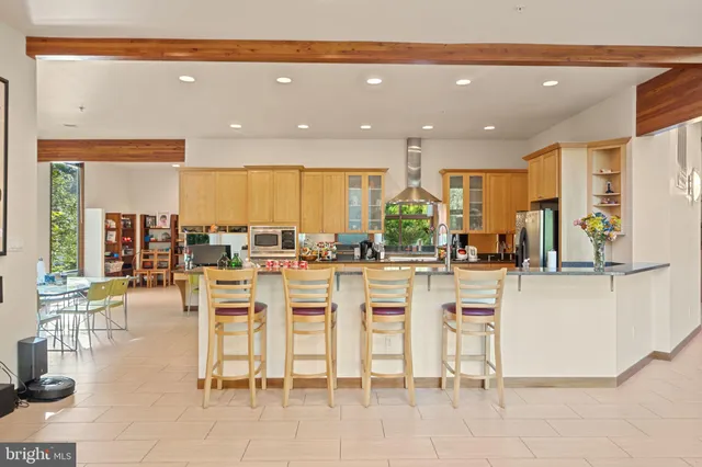 a living room with furniture a fireplace and a floor to ceiling window