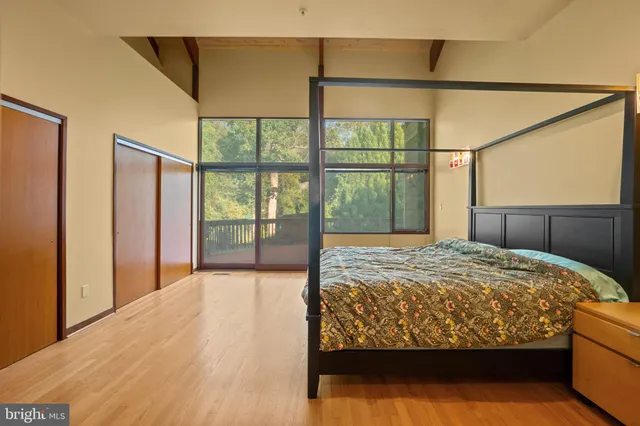 a bedroom with a large bed and a chandelier