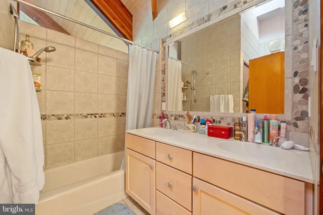 a bedroom with furniture and a large window