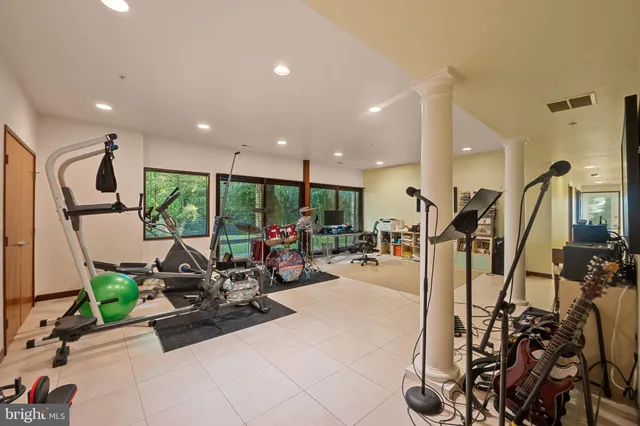 a room with gym equipment and a large window