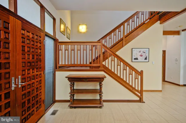 a view of entryway with wooden floor and door