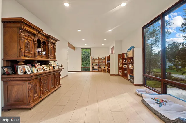 a large kitchen with stainless steel appliances kitchen island granite countertop a large window