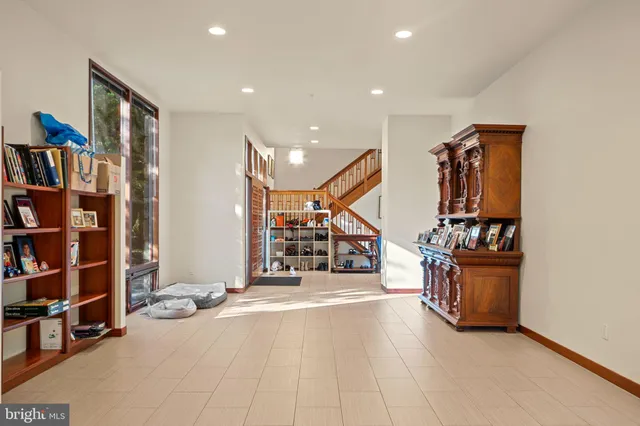 a dining hall with stainless steel appliances kitchen island granite countertop a dining table and chairs