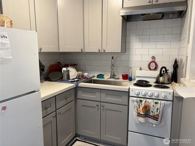 a kitchen with a sink stove and cabinets