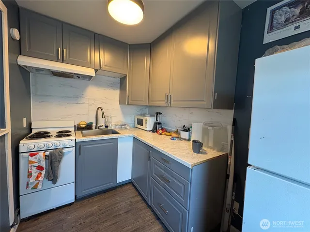a kitchen with a stove and a sink