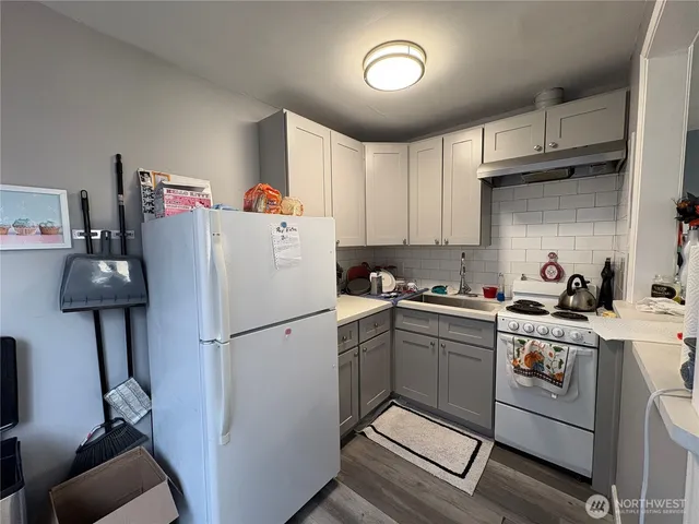 a white refrigerator freezer sitting inside of a kitchen
