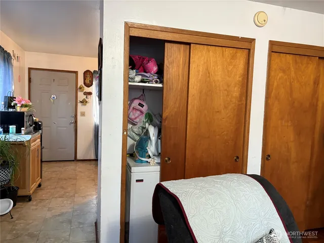 a bed room with a bed and a painting on the wall