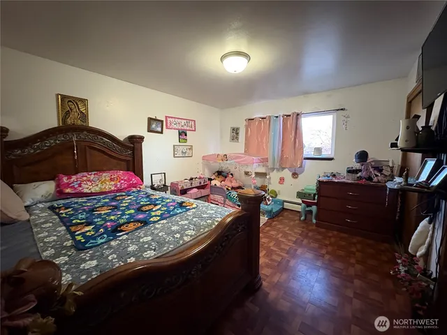 a bed room with furniture and a flat screen tv