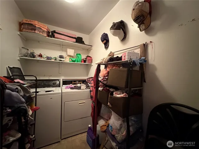 a storage and utility room with a washer and dryer