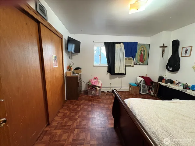 a bedroom with a bed and a flat screen tv