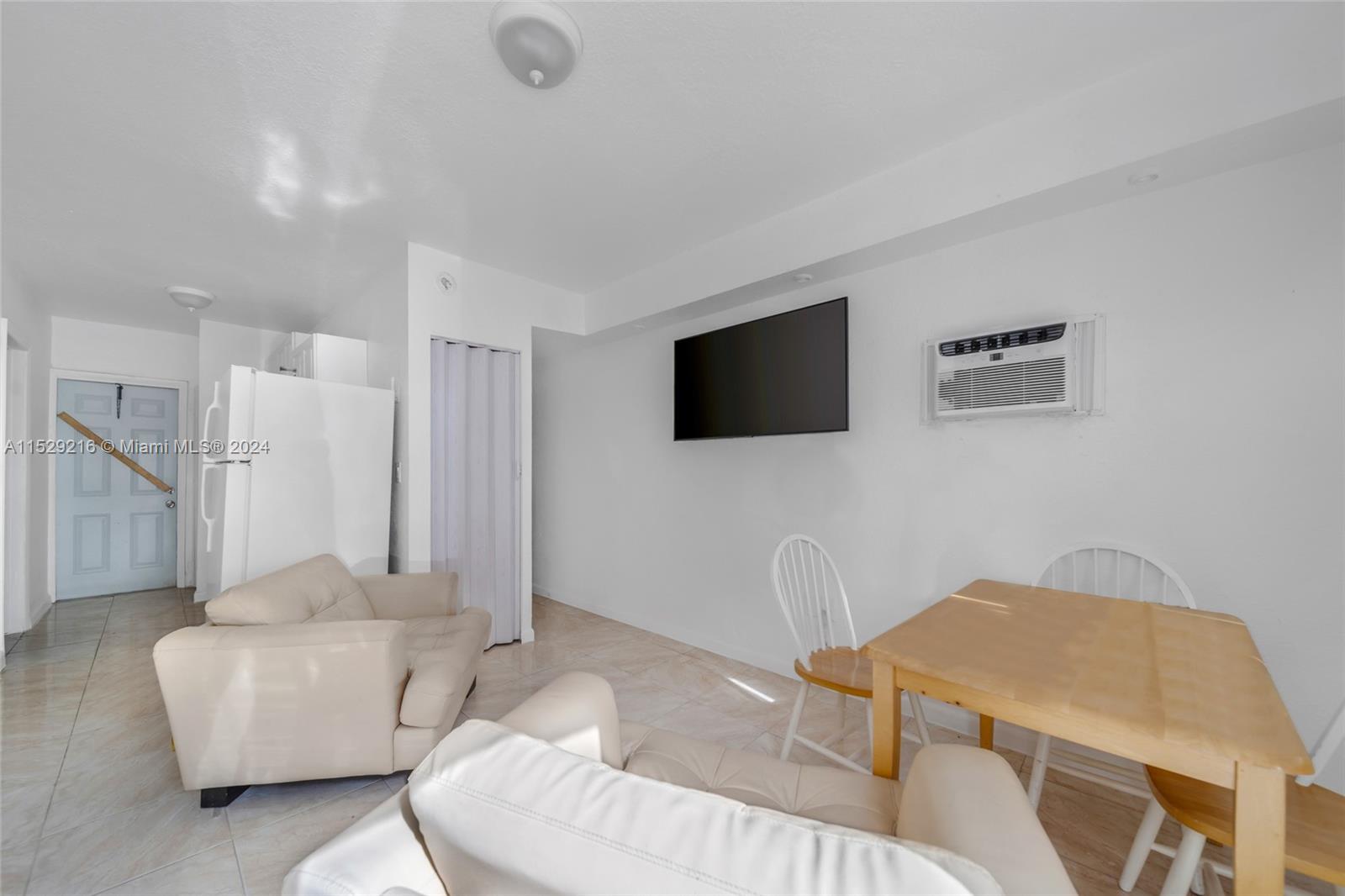 1219 Sharazad Boulevard Opa-Locka, FL 33054 - Photo 14 of 16 a living room with furniture and a flat screen tv