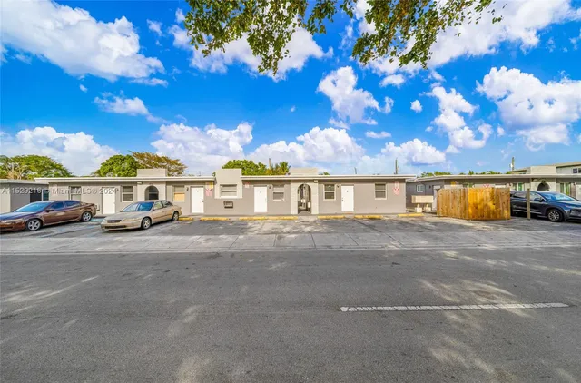 a front view of a house with a yard and sitting area