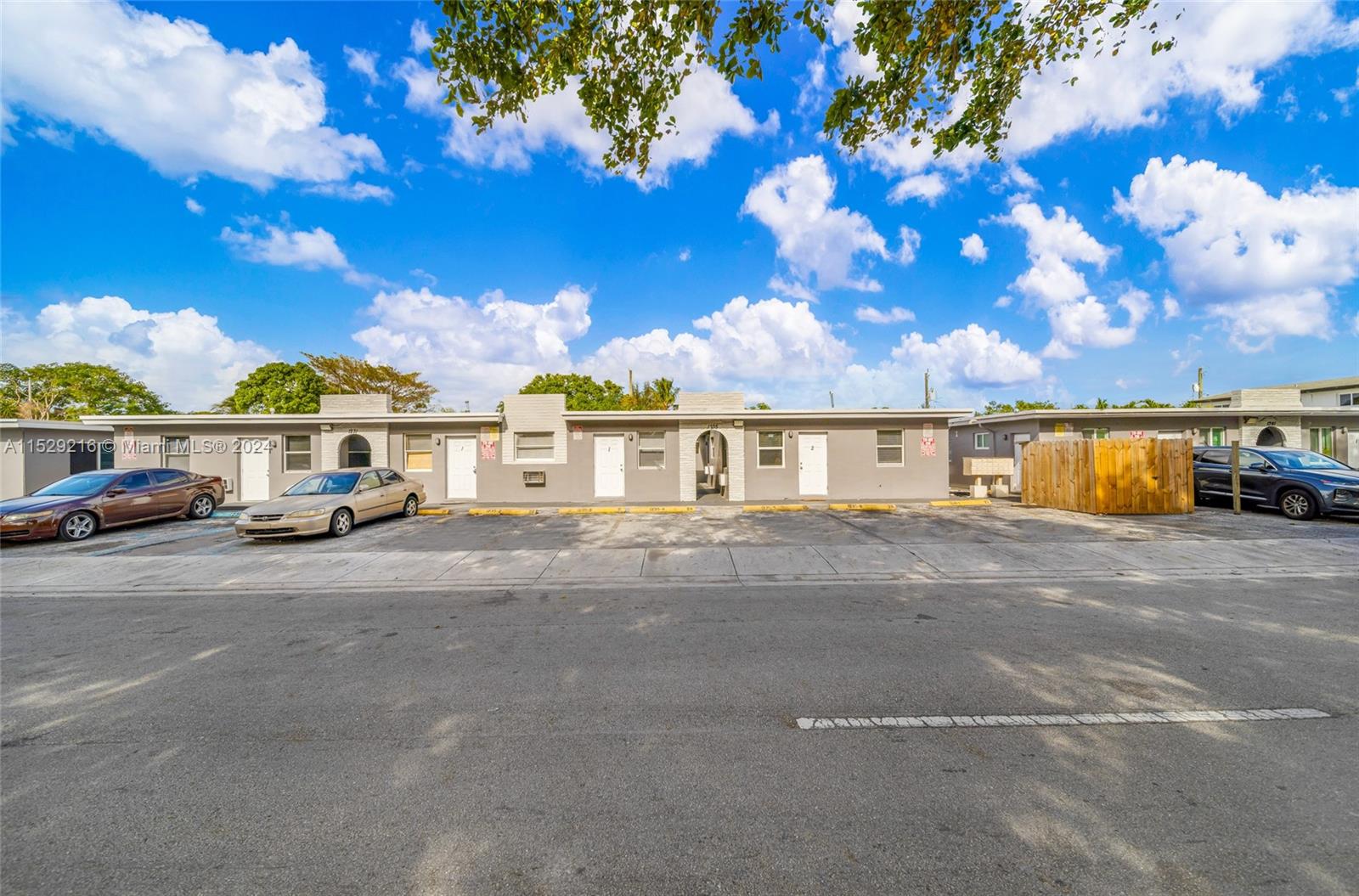 1219 Sharazad Boulevard Opa-Locka, FL 33054 - Photo 2 of 16 a front view of a house with a yard and sitting area