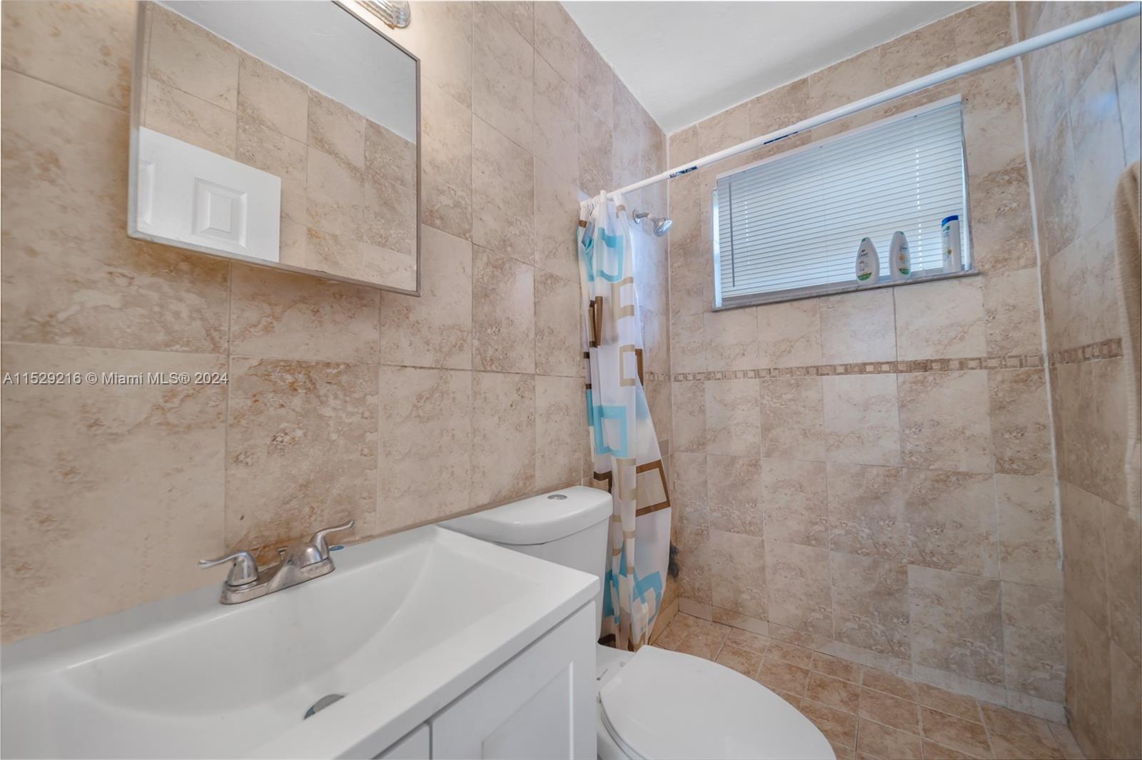 1219 Sharazad Boulevard Opa-Locka, FL 33054 - Photo 4 of 16 a bathroom with a sink toilet and shower