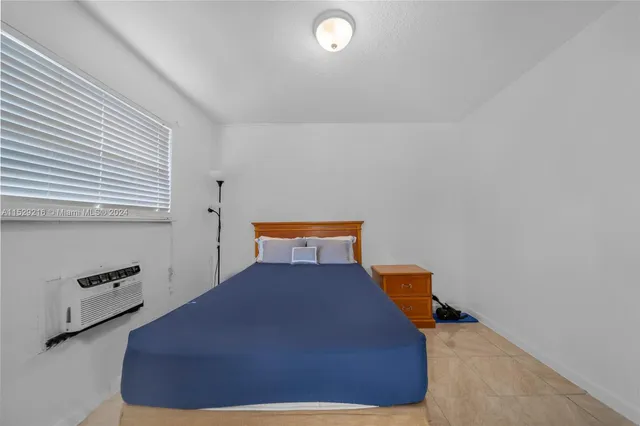 a bed room with a bed and a window