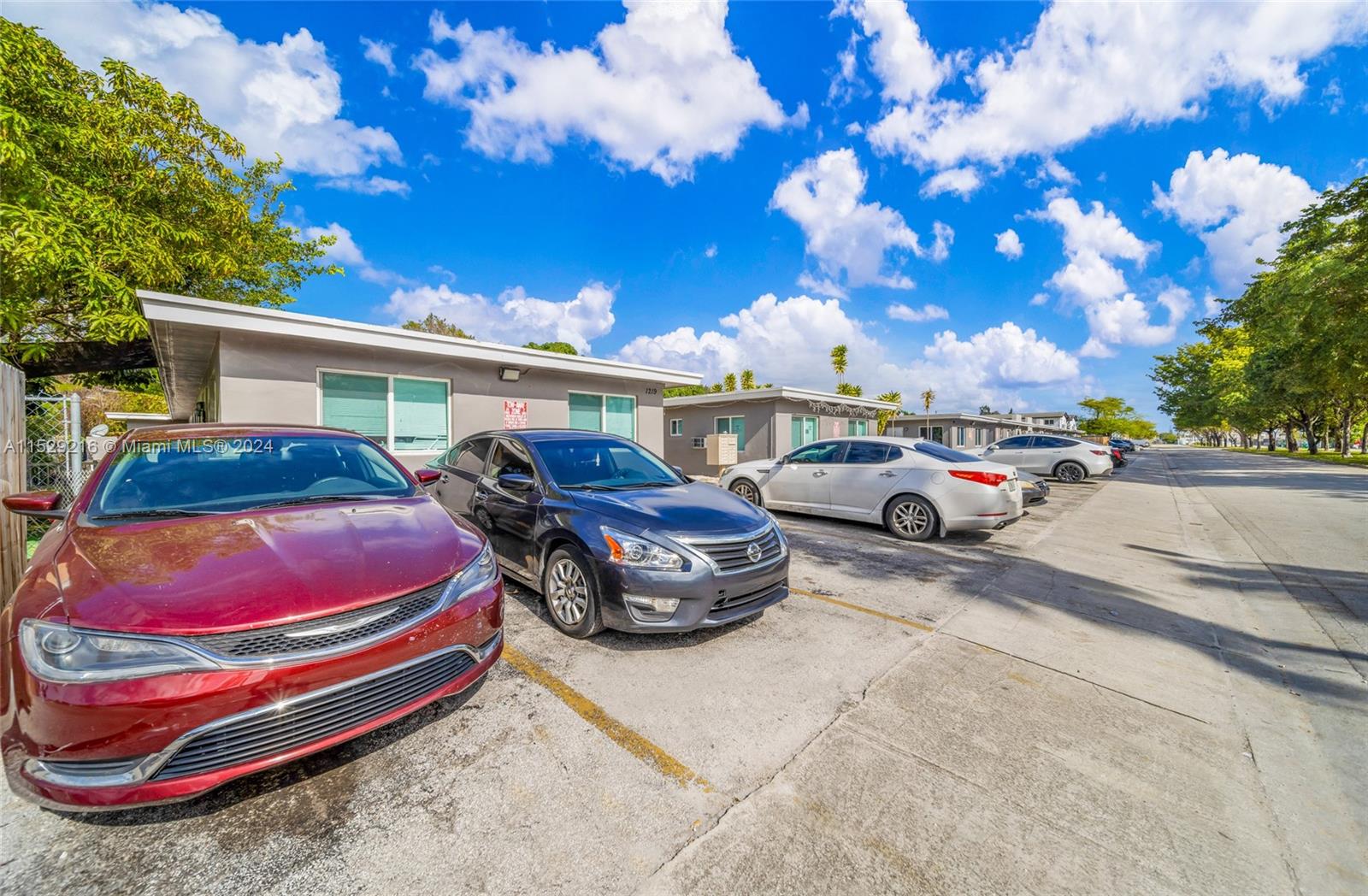 1219 Sharazad Boulevard Opa-Locka, FL 33054 - Photo 10 of 16 a front view of a house with garden and parking space