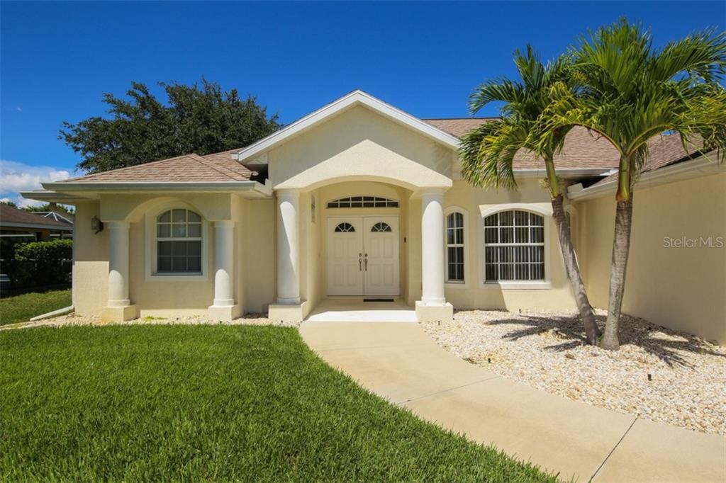 210 Marker Road Rotonda West, FL 33947 - Photo 1 of 1 Double Door Entrance waiting for your landscaping touch