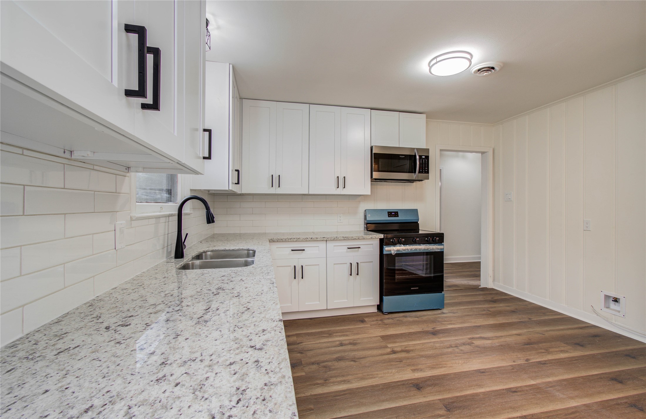 2417 Pecan Street Dickinson, TX 77539 - Photo 20 of 43 a kitchen with granite countertop a stove and a sink