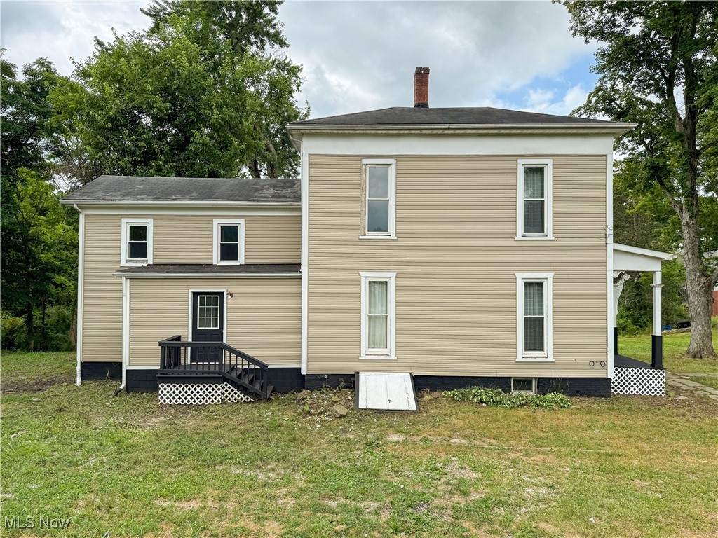 6118 Institute Road Rome, OH 44085 - Photo 19 of 27 Back of house with a lawn and a chimney