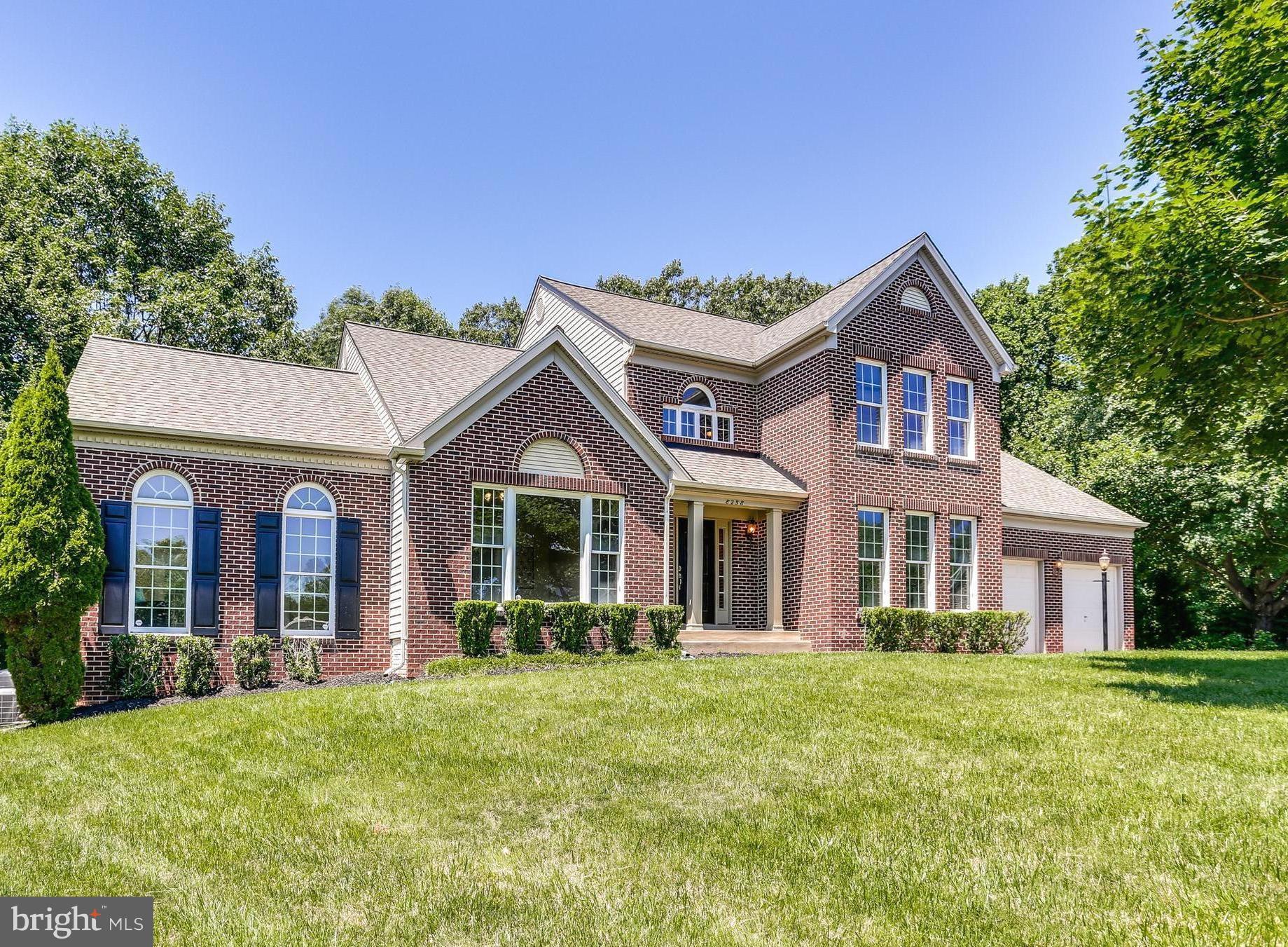 8258 Spring Branch Court Laurel, MD 20723 - Photo 1 of 26 a front view of a house with a garden