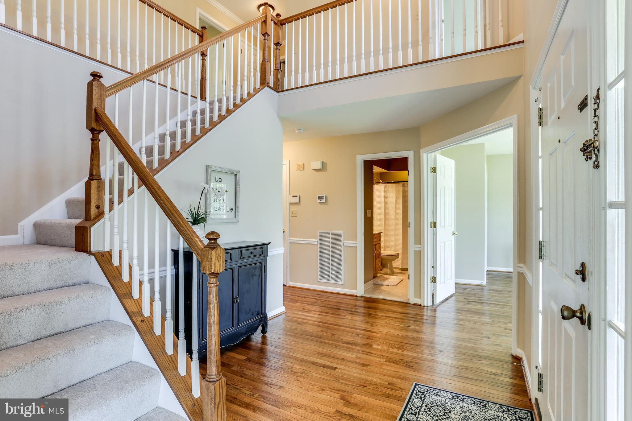 8258 Spring Branch Court Laurel, MD 20723 - Photo 2 of 26 a view of an entryway with wooden floor and stairs