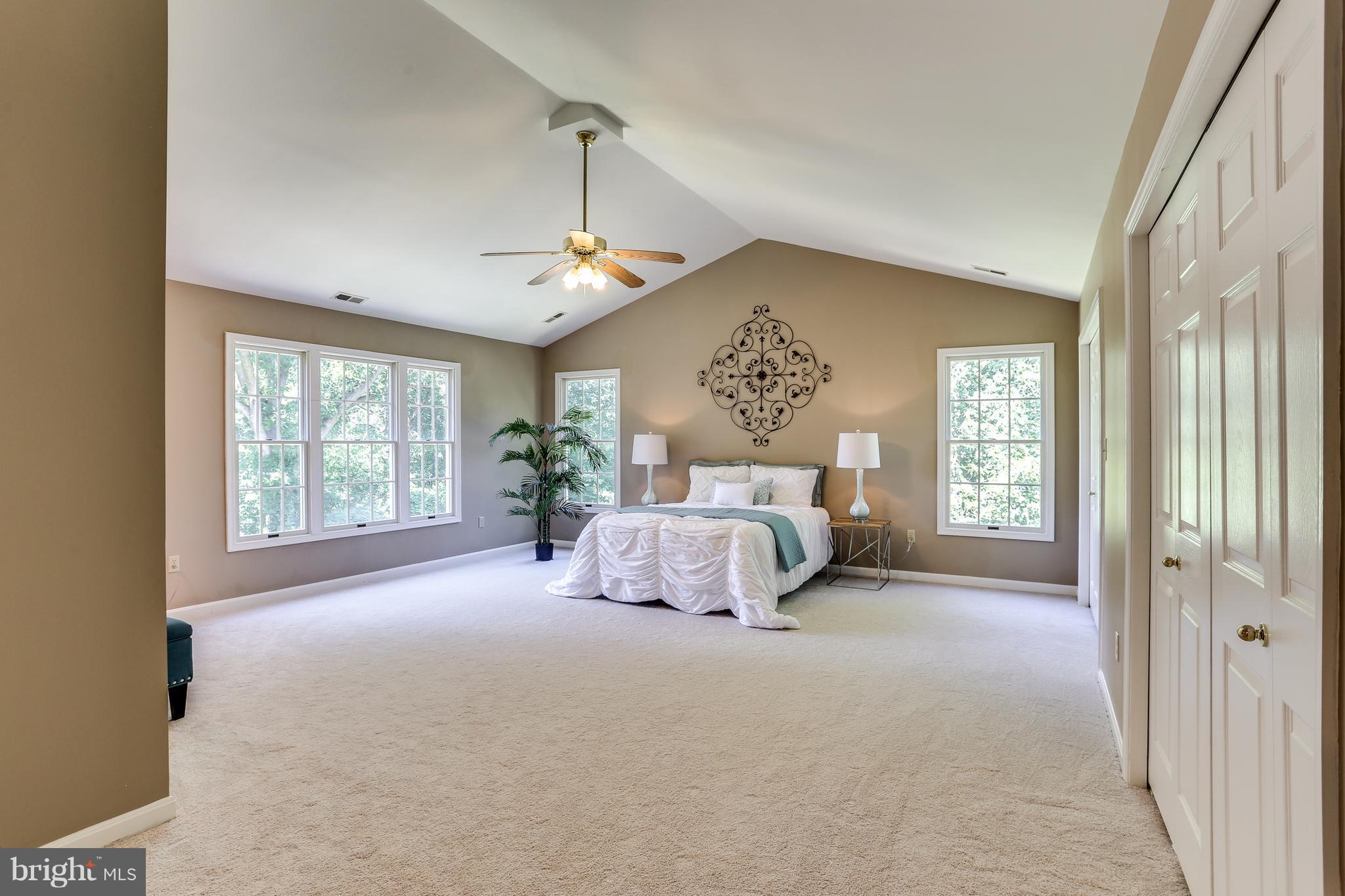 8258 Spring Branch Court Laurel, MD 20723 - Photo 15 of 26 a spacious bedroom with a large bed and a window