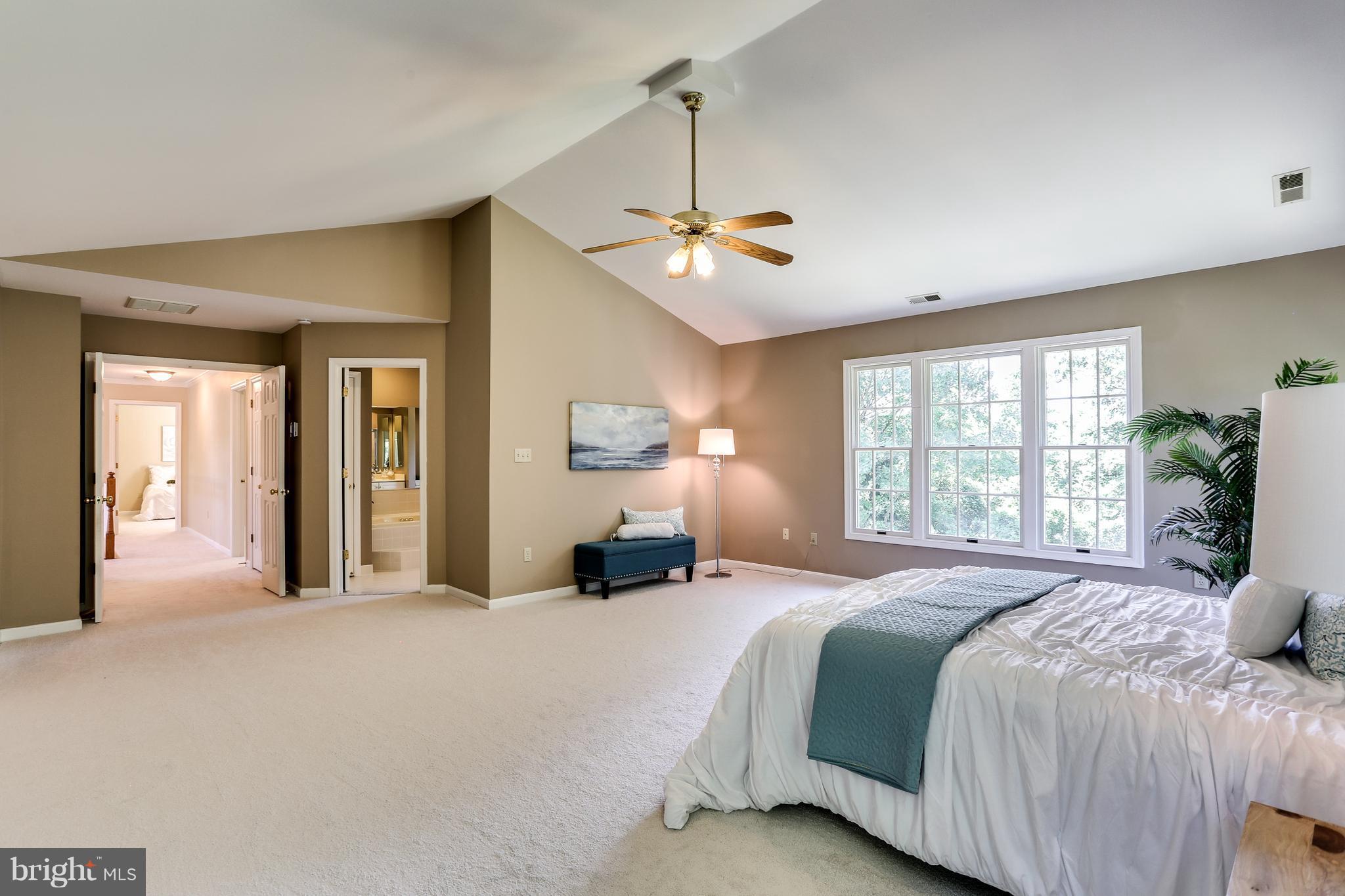 8258 Spring Branch Court Laurel, MD 20723 - Photo 16 of 26 a bedroom with a large bed and a chandelier