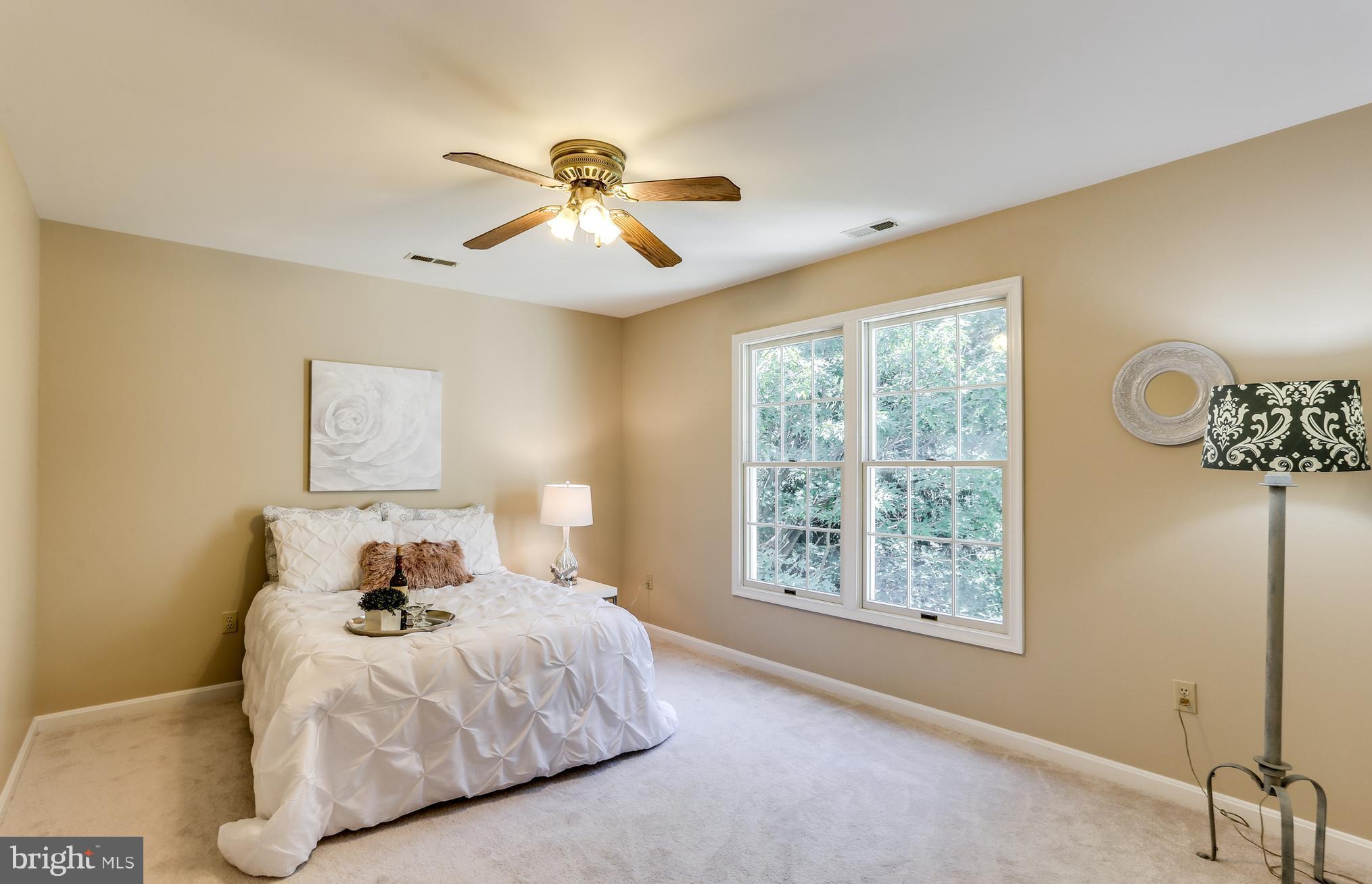 8258 Spring Branch Court Laurel, MD 20723 - Photo 18 of 26 a bedroom with a bed and a window