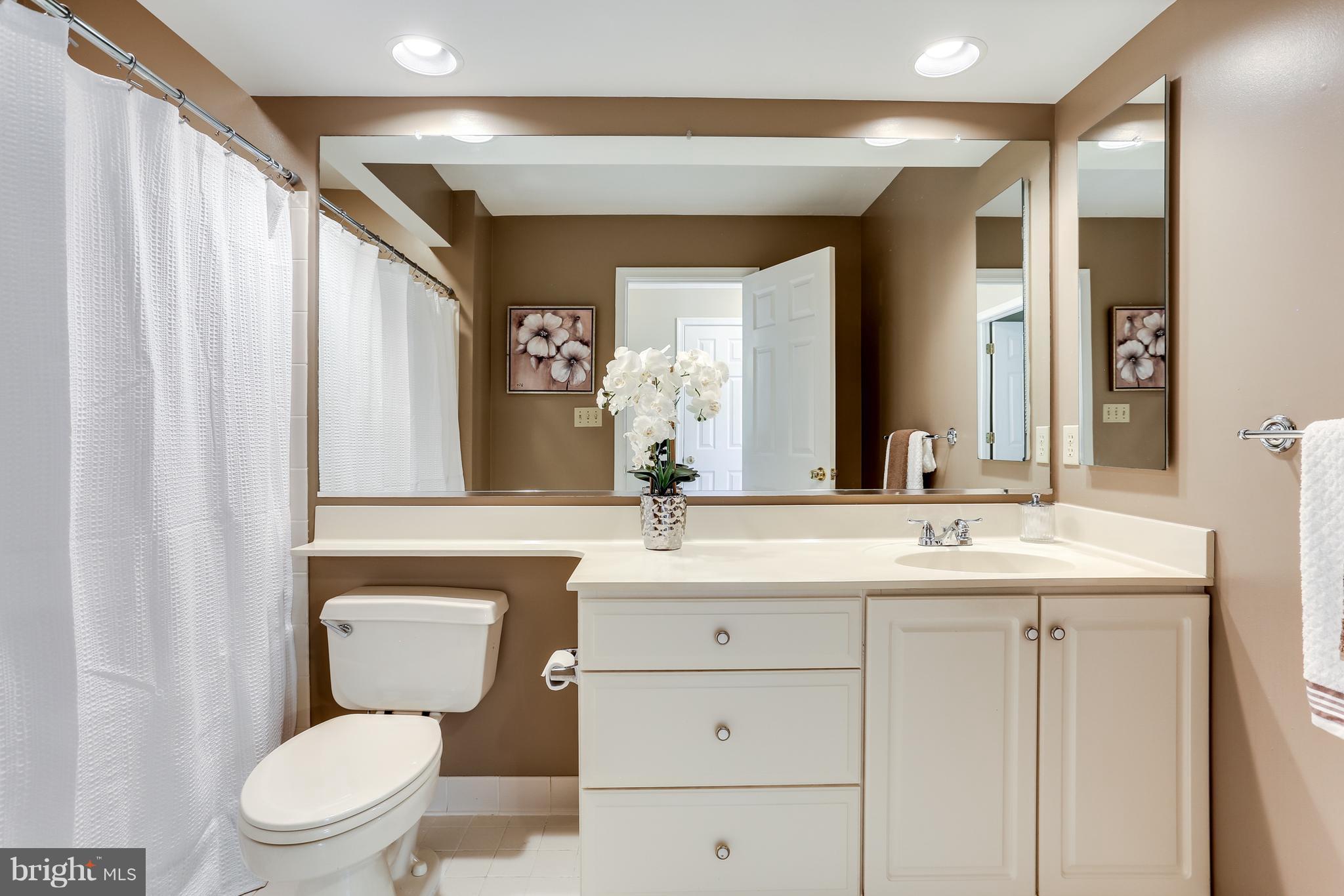8258 Spring Branch Court Laurel, MD 20723 - Photo 19 of 26 a bathroom with a toilet sink and mirror